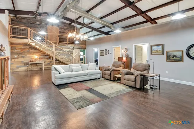 a living room with furniture and a chandelier