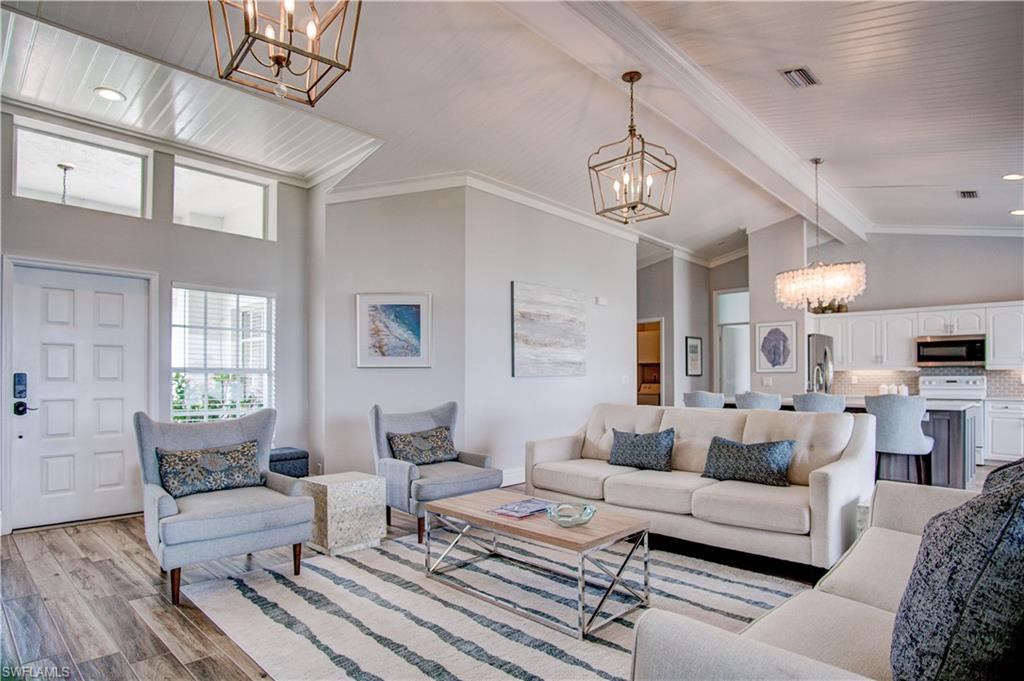 7271 Mill Pond Circle Naples, FL 34109 - Photo 1 of 45 a living room with furniture kitchen view and a chandelier