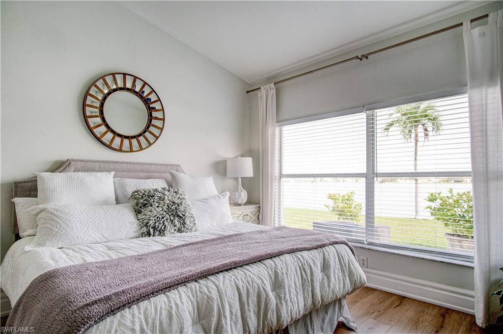7271 Mill Pond Circle Naples, FL 34109 - Photo 12 of 45 a bedroom with a large bed and a window