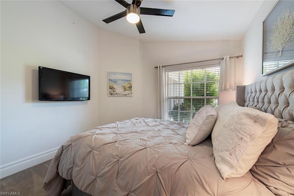 7271 Mill Pond Circle Naples, FL 34109 - Photo 15 of 45 a bedroom with a bed and a flat screen tv