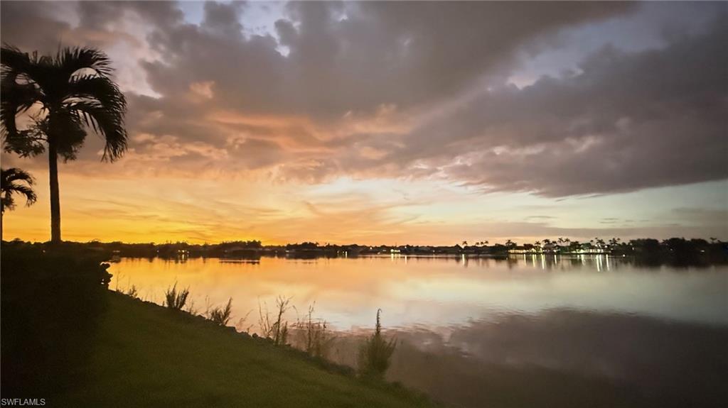 7271 Mill Pond Circle Naples, FL 34109 - Photo 39 of 45 a view of a lake with houses in the back