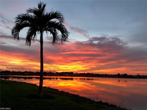 a kitchen with stainless steel appliances a table and chairs in it