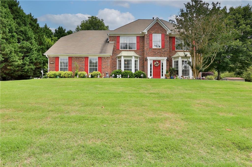 1740 Big Haynes Court Southwest Grayson, GA 30017 - Photo 1 of 1 front view of a brick house with a yard