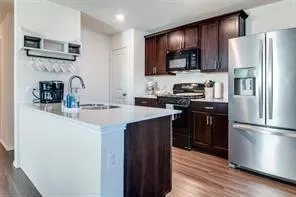 a kitchen with a refrigerator and a sink