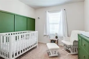 a white bed sitting in a bedroom next to a window