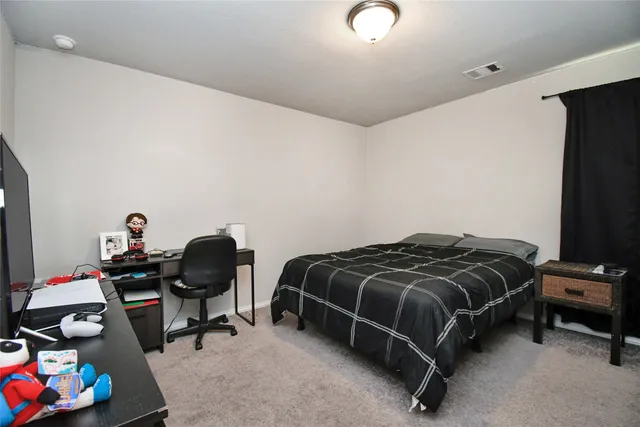 a bedroom with a bed and a chair