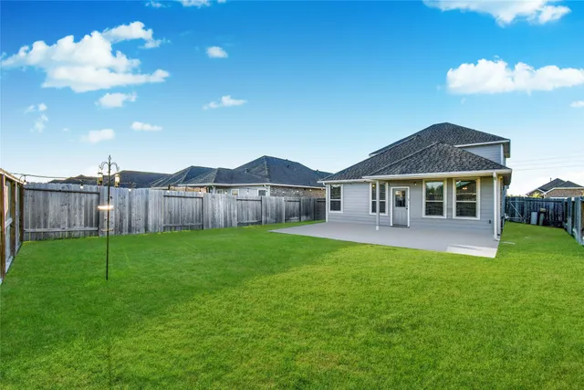 a view of an house with backyard space and garden