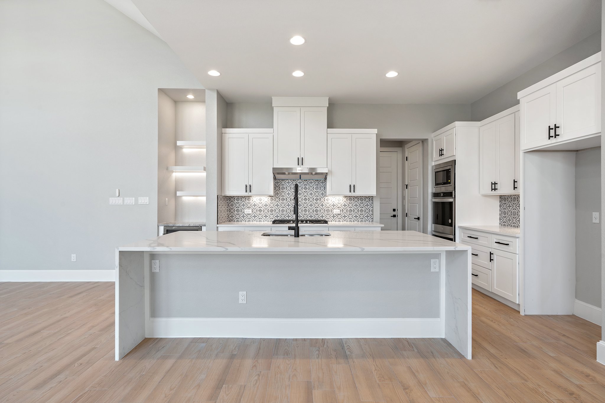 308 Axis Loop Georgetown, TX 78628 - Photo 15 of 40 a large kitchen with stainless steel appliances a large counter top a stove and a refrigerator