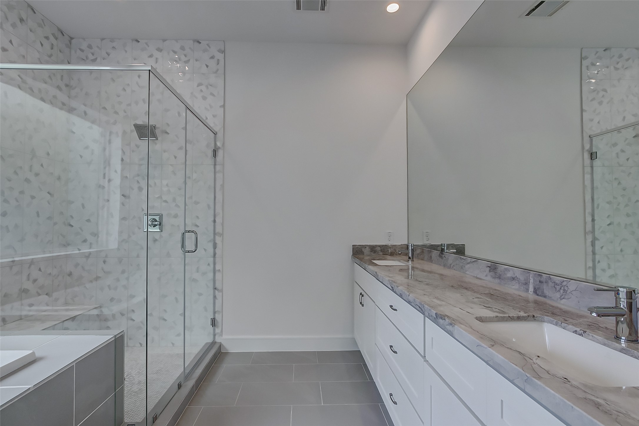 8926 Spring Knoll Forest Drive Houston, TX 77080 - Photo 19 of 22 a bathroom with a granite countertop sink a mirror and a bathtub