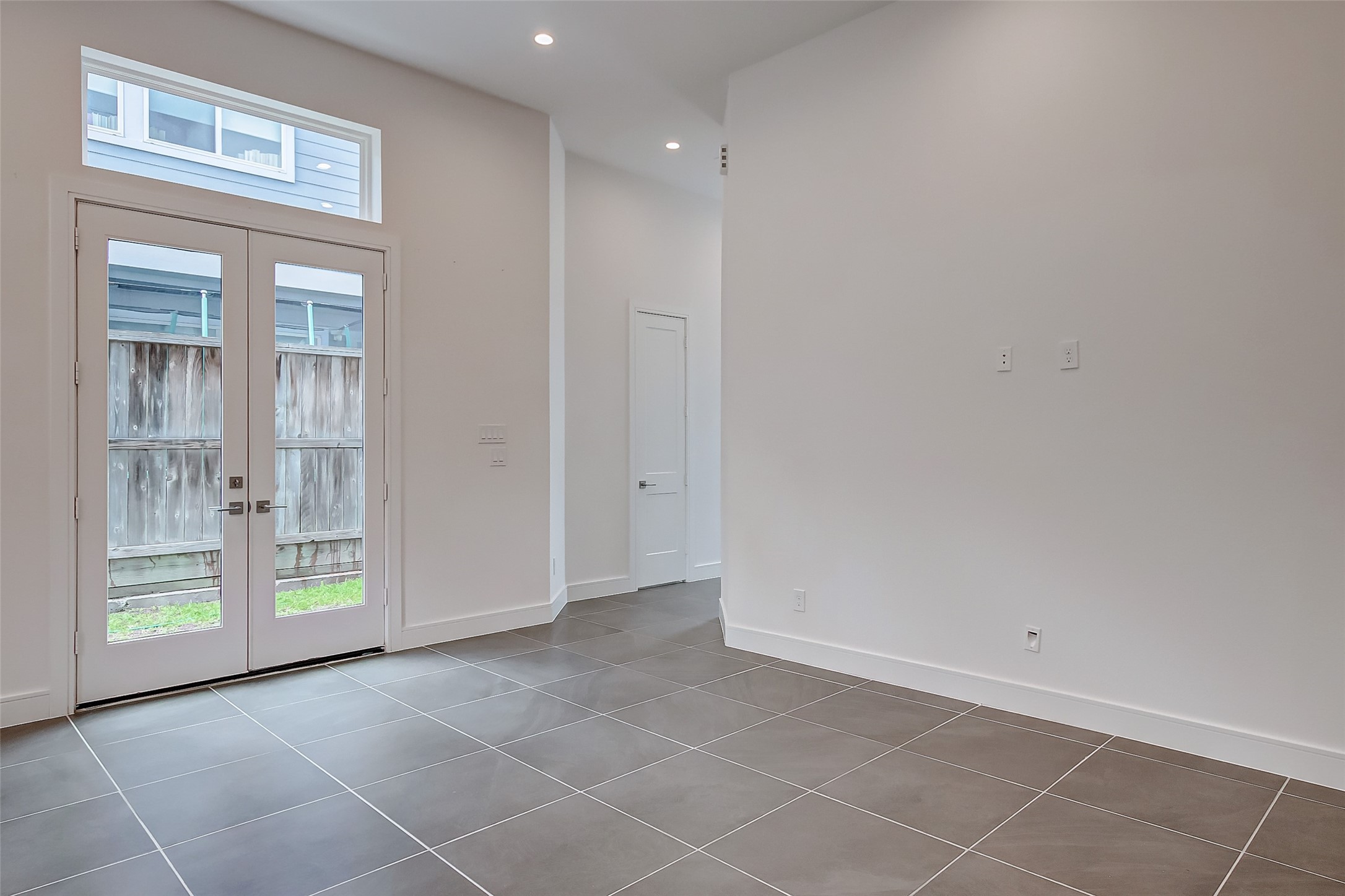 8926 Spring Knoll Forest Drive Houston, TX 77080 - Photo 3 of 22 a view of an empty room with glass door