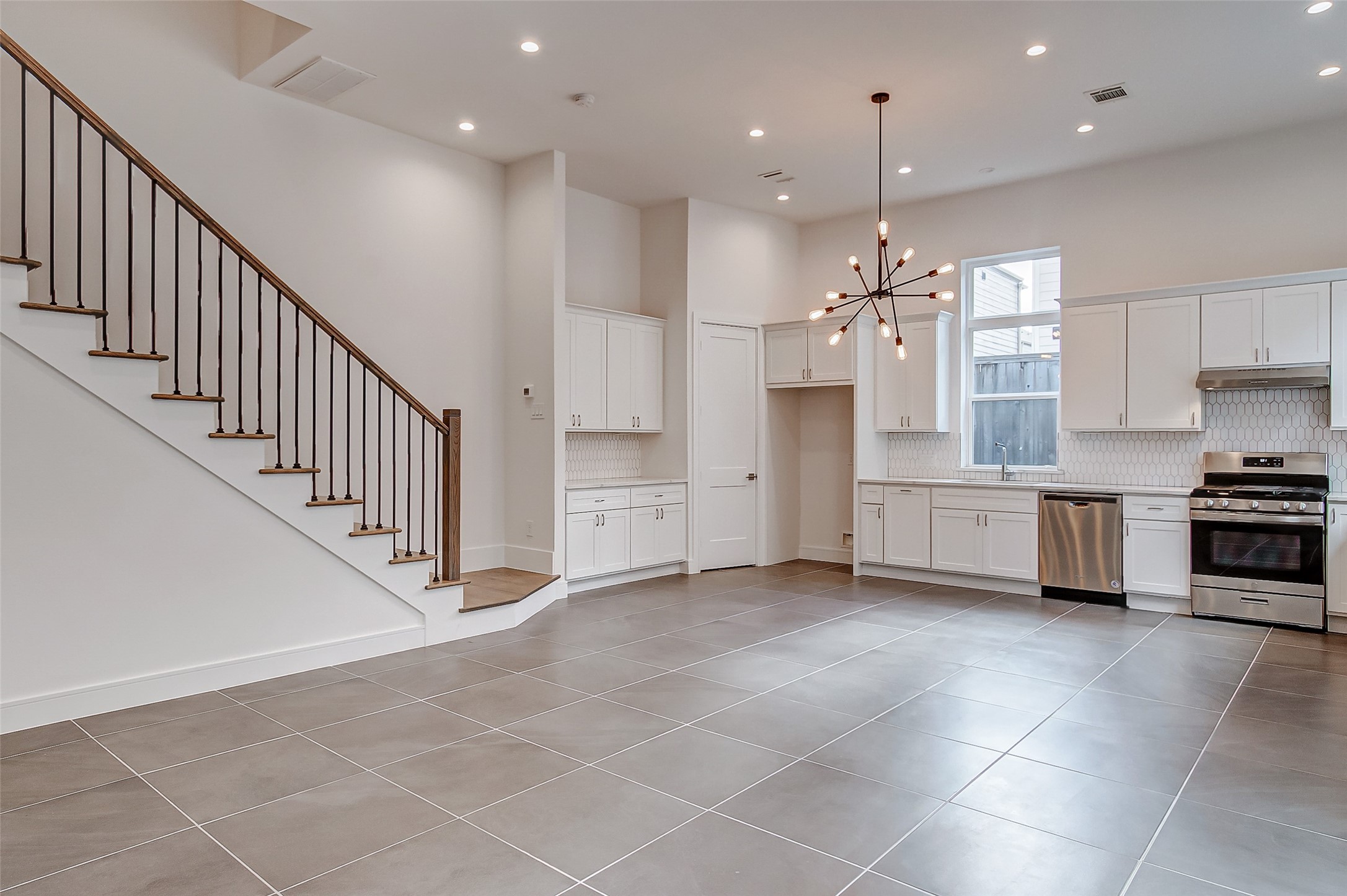 8926 Spring Knoll Forest Drive Houston, TX 77080 - Photo 4 of 22 a view of a kitchen with an entryway and cabinets