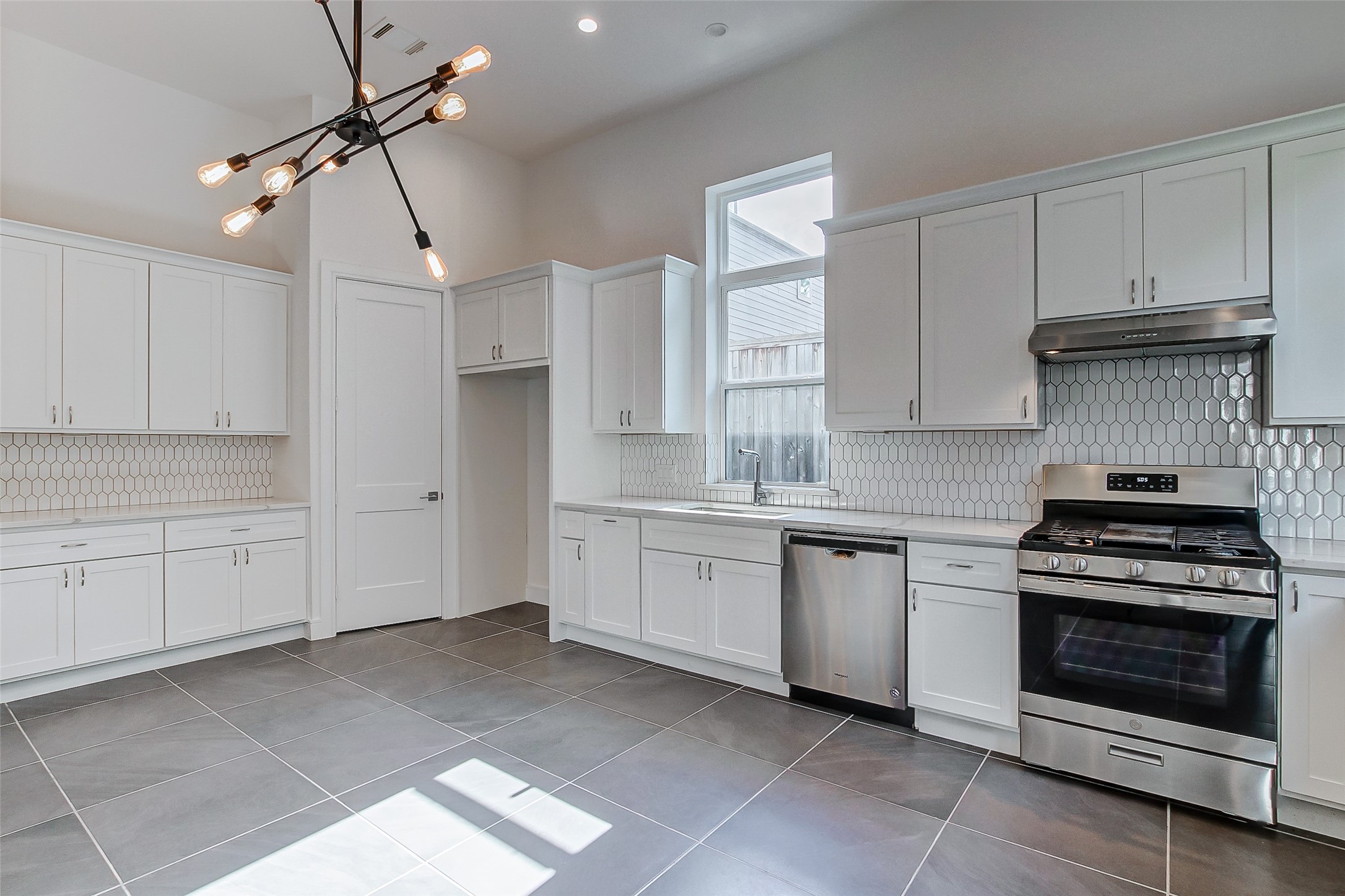 8926 Spring Knoll Forest Drive Houston, TX 77080 - Photo 6 of 22 a kitchen with granite countertop a stove sink and cabinets