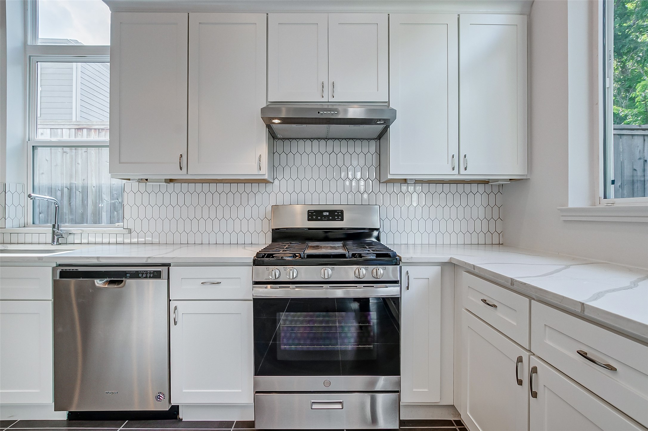 8926 Spring Knoll Forest Drive Houston, TX 77080 - Photo 7 of 22 a kitchen with granite countertop white cabinets and a stove