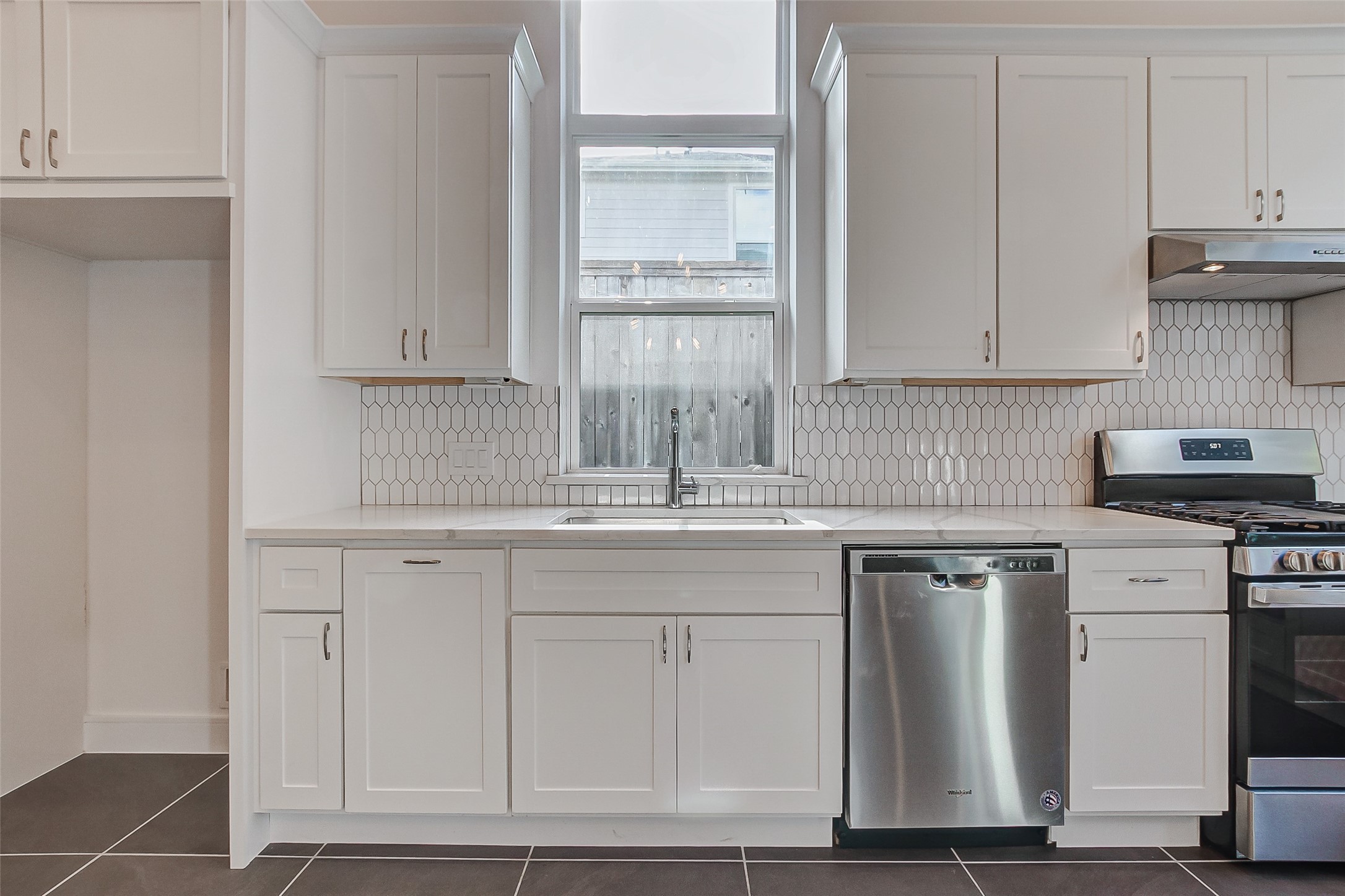 8926 Spring Knoll Forest Drive Houston, TX 77080 - Photo 9 of 22 a kitchen with cabinets appliances and a window