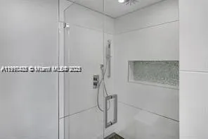 a view of a room with a ceiling fan and a window