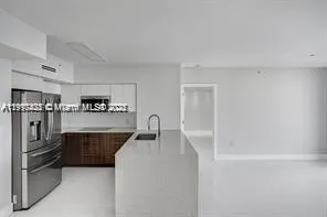a kitchen with stainless steel appliances a refrigerator and a sink