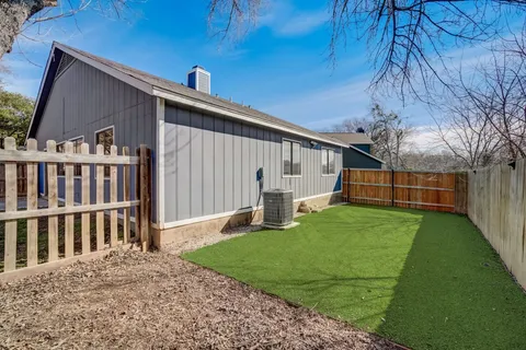 a view of a house with backyard and porch