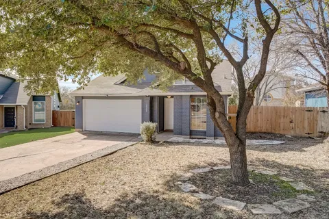 a backyard of a house with large trees and a tree