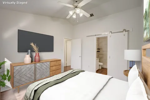 a bedroom with a bed and a chandelier