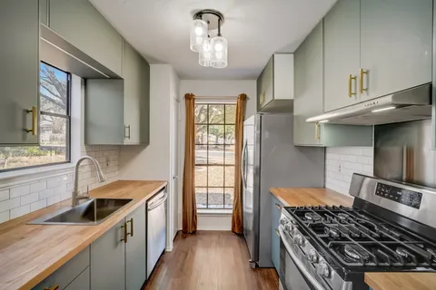 a kitchen with a stove and a sink