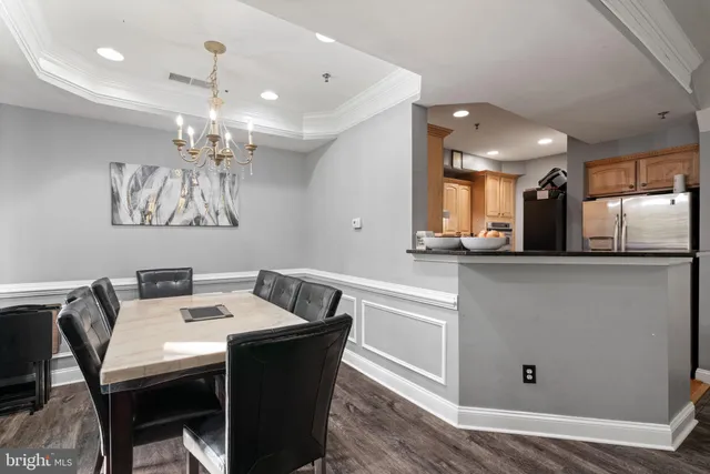 a view of a dining room with furniture wooden floor and chandelier