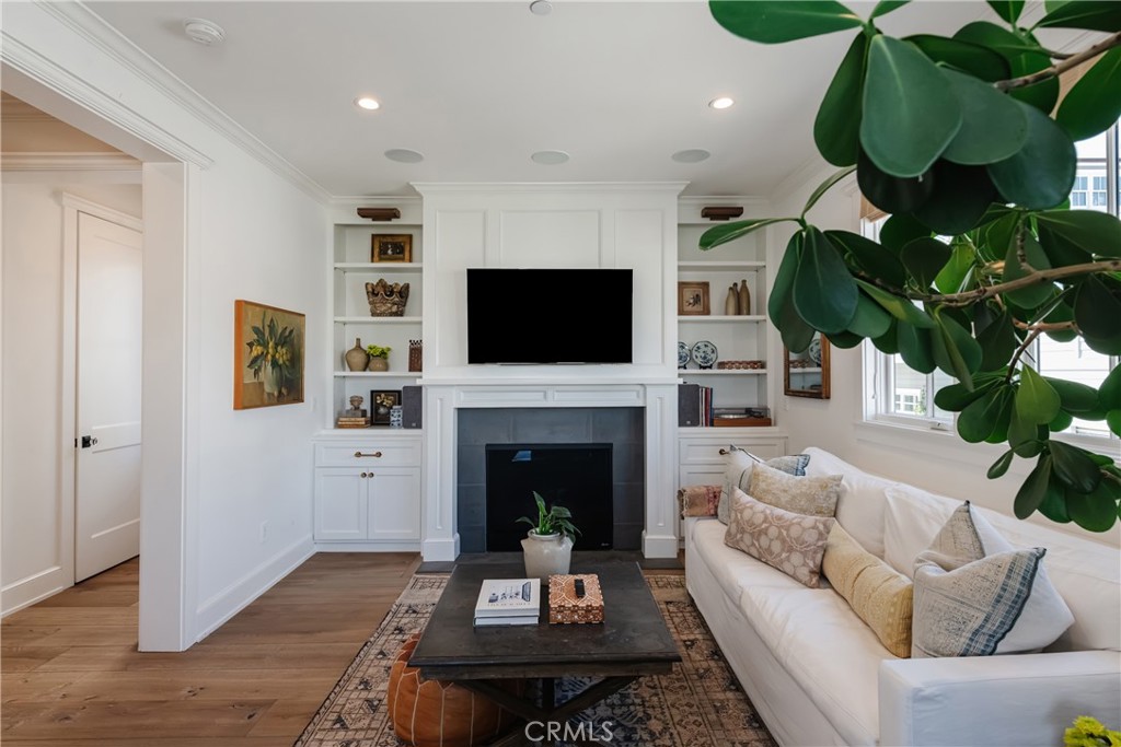 441 3rd Street Manhattan Beach, CA 90266 - Photo 16 of 30 a living room with furniture a fireplace and a flat screen tv