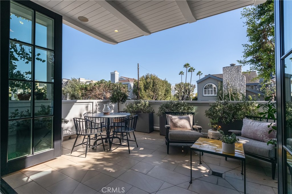 441 3rd Street Manhattan Beach, CA 90266 - Photo 4 of 30 a view of a patio with couches table and chairs and potted plants