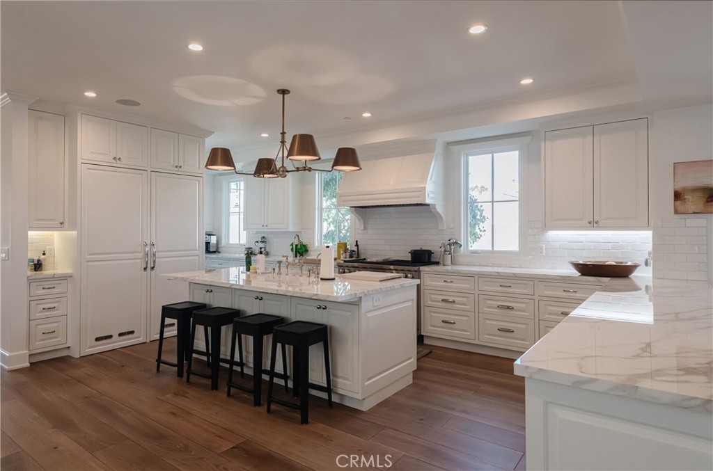 441 3rd Street Manhattan Beach, CA 90266 - Photo 5 of 30 a kitchen with stainless steel appliances kitchen island granite countertop a table chairs sink and cabinets