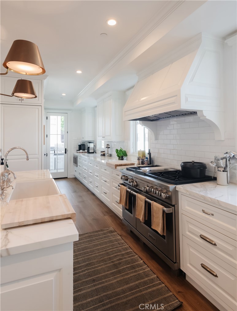 441 3rd Street Manhattan Beach, CA 90266 - Photo 6 of 30 a kitchen with stainless steel appliances granite countertop a stove a sink and a refrigerator