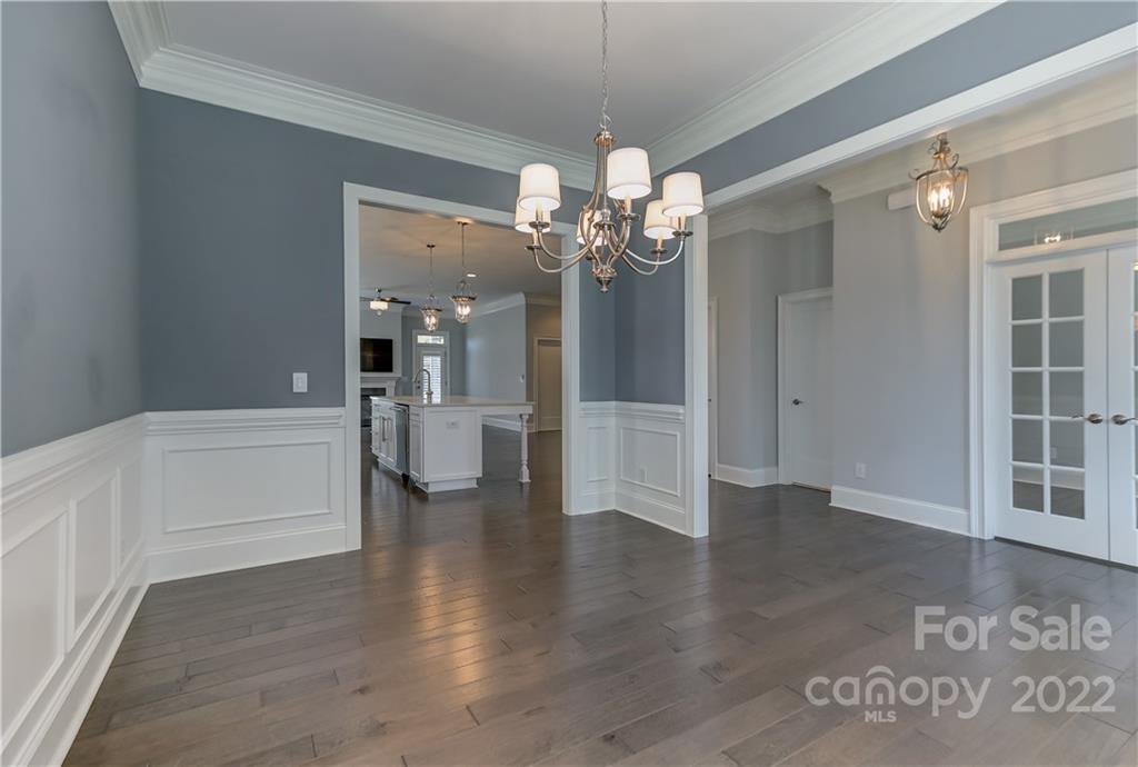 320 Sensibility Circle Fort Mill, SC 29708 - Photo 11 of 48 a view of a hallway with wooden floor and a chandelier