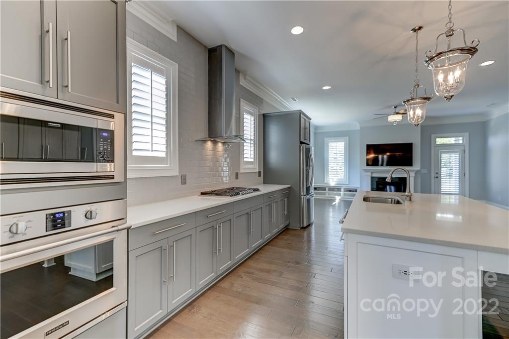 320 Sensibility Circle Fort Mill, SC 29708 - Photo 16 of 48 a large kitchen with kitchen island a large counter space a sink appliances and cabinets