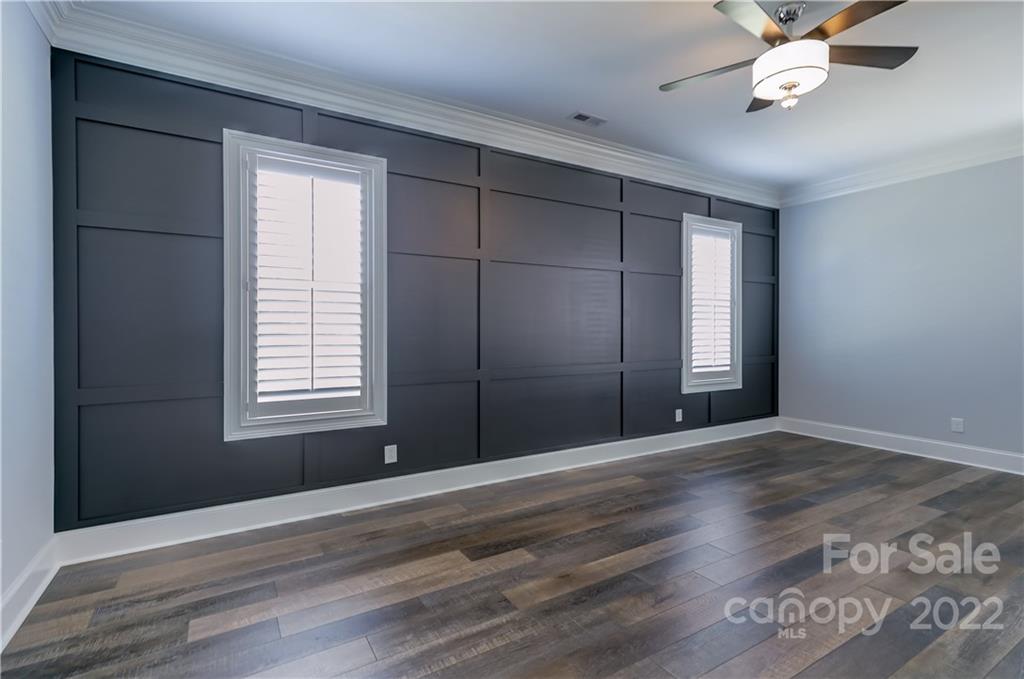 320 Sensibility Circle Fort Mill, SC 29708 - Photo 23 of 48 an empty room with wooden floor fan and windows