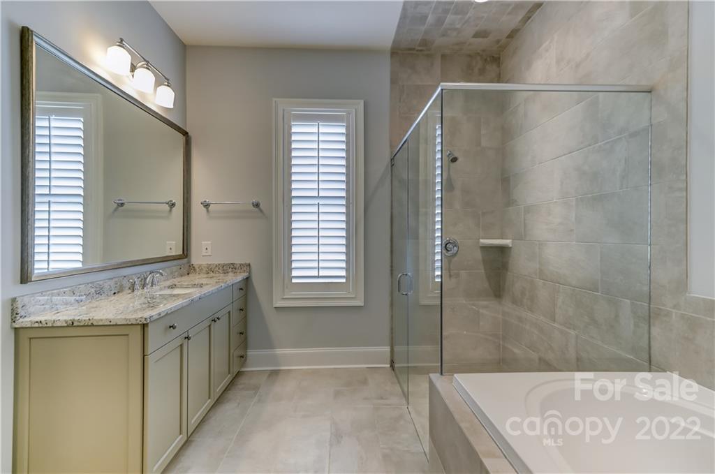 320 Sensibility Circle Fort Mill, SC 29708 - Photo 27 of 48 a bathroom with a granite countertop sink a mirror and shower