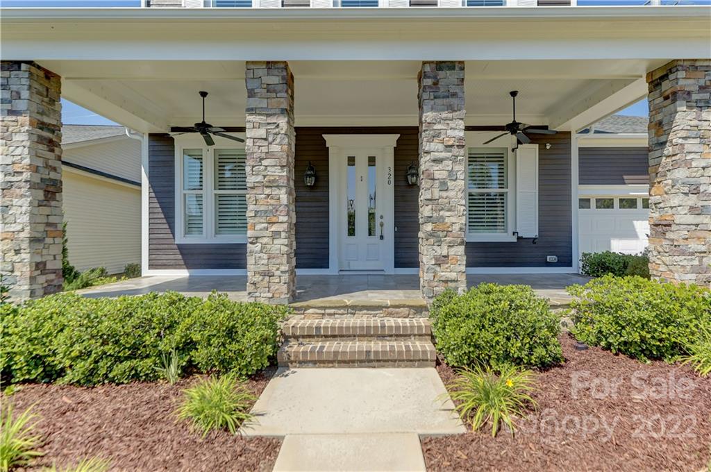 320 Sensibility Circle Fort Mill, SC 29708 - Photo 3 of 48 front view of a brick house with potted plants