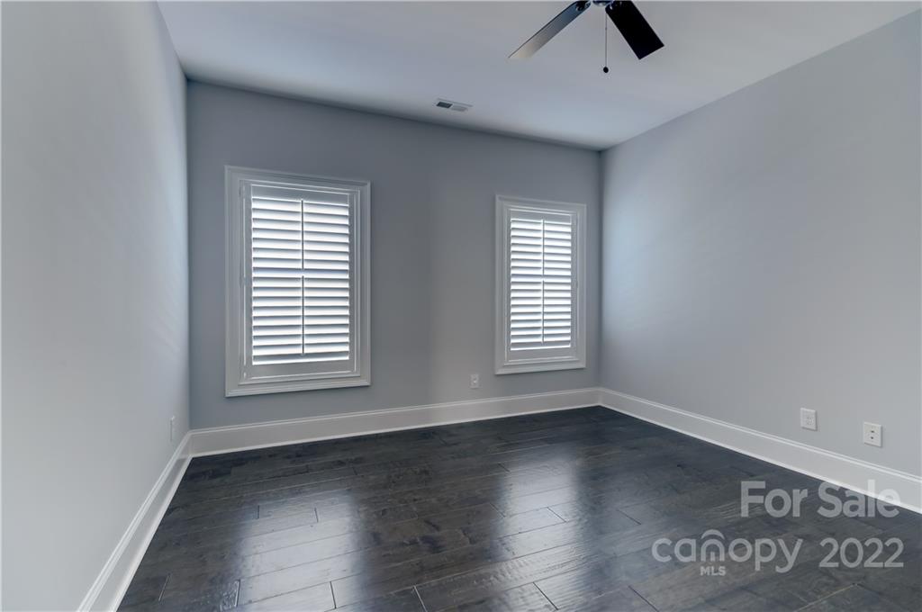 320 Sensibility Circle Fort Mill, SC 29708 - Photo 32 of 48 an empty room with wooden floor and windows