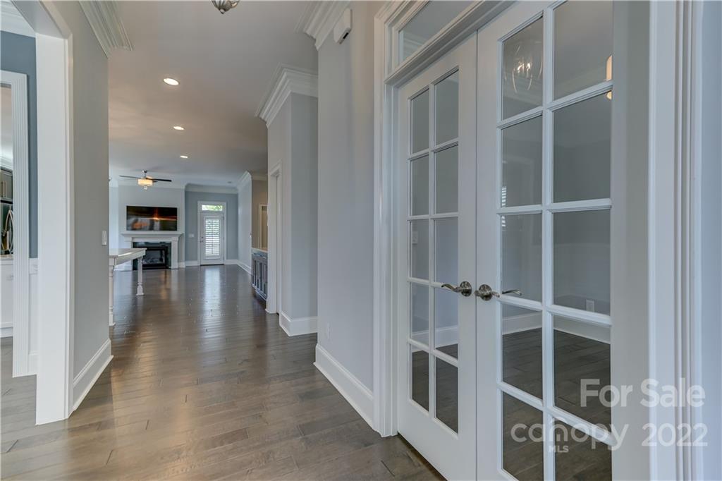 320 Sensibility Circle Fort Mill, SC 29708 - Photo 6 of 48 a hallway with wooden floors and a kitchen view