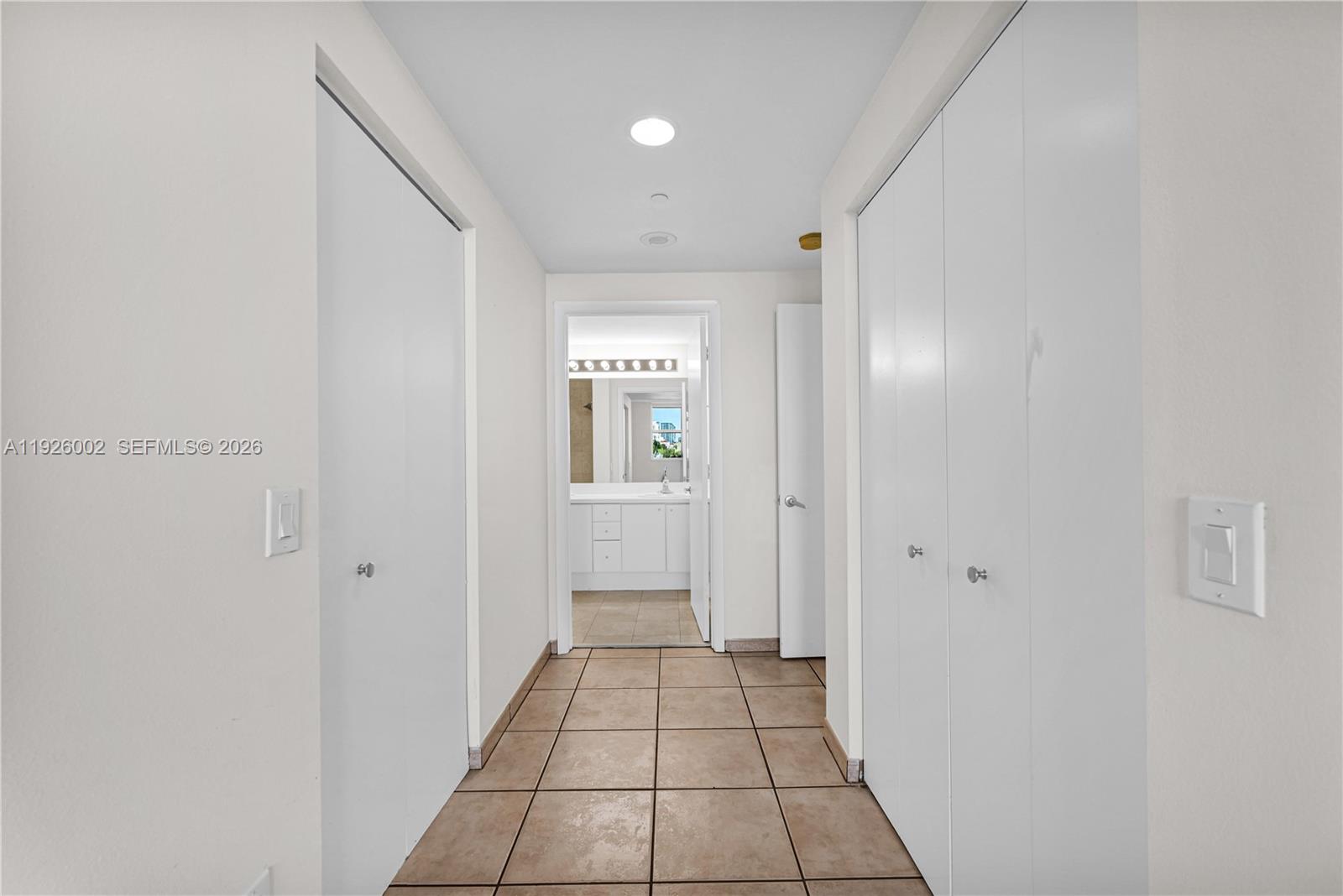 2475 Brickell Avenue, Unit 703 Miami, FL 33129 - Photo 15 of 30 a view of a hallway with wooden floor and a bathroom