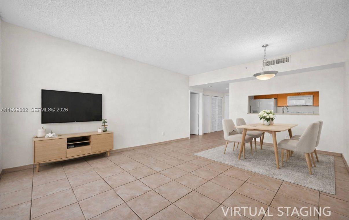 2475 Brickell Avenue, Unit 703 Miami, FL 33129 - Photo 6 of 30 a view of a livingroom with furniture and flat screen tv