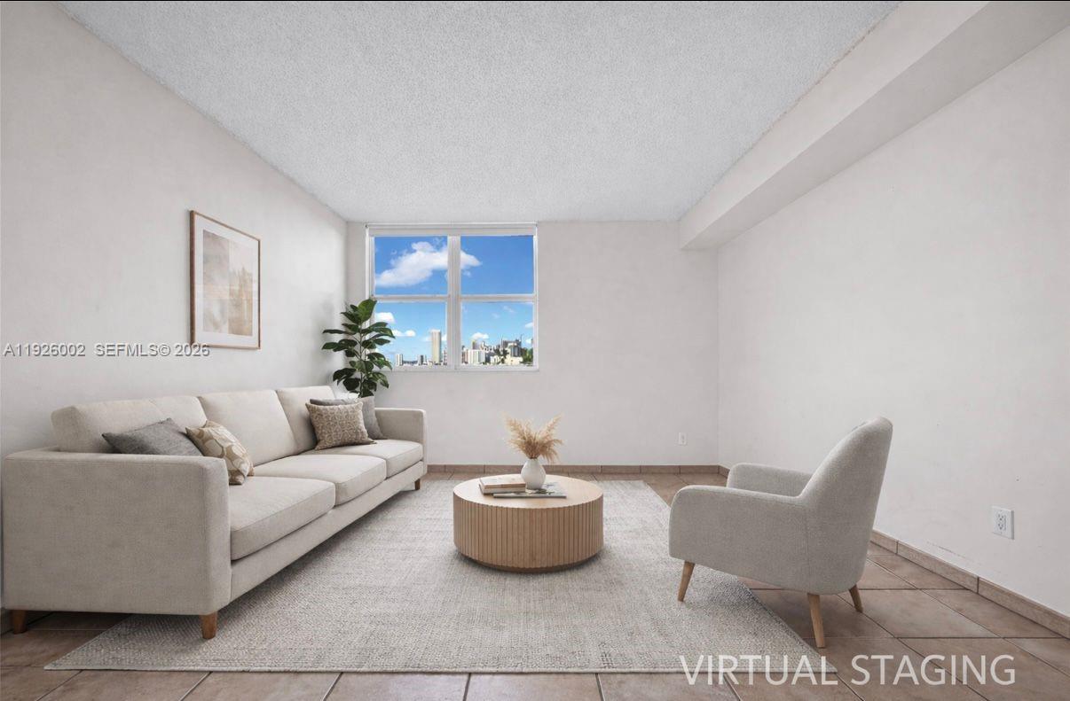 2475 Brickell Avenue, Unit 703 Miami, FL 33129 - Photo 9 of 30 a living room with furniture and a potted plant