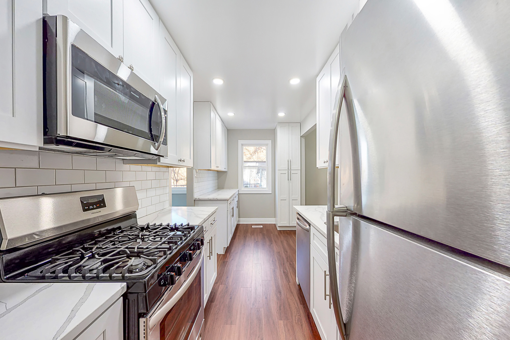 141 Mellbrook Road Bolingbrook, IL 60440 - Photo 7 of 20 a kitchen with stainless steel appliances granite countertop a stove a sink and a microwave