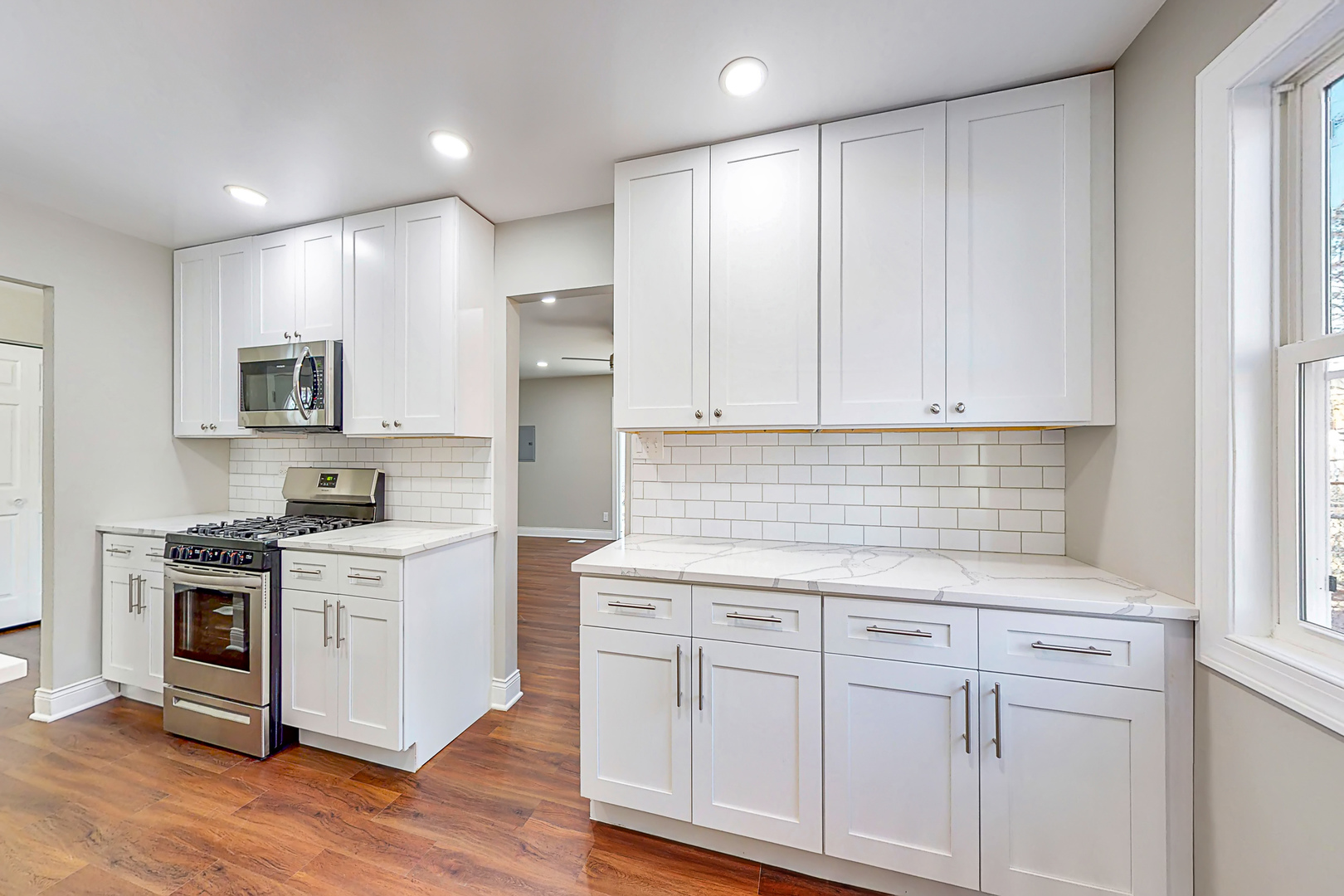 141 Mellbrook Road Bolingbrook, IL 60440 - Photo 9 of 20 a kitchen with white cabinets and stainless steel appliances