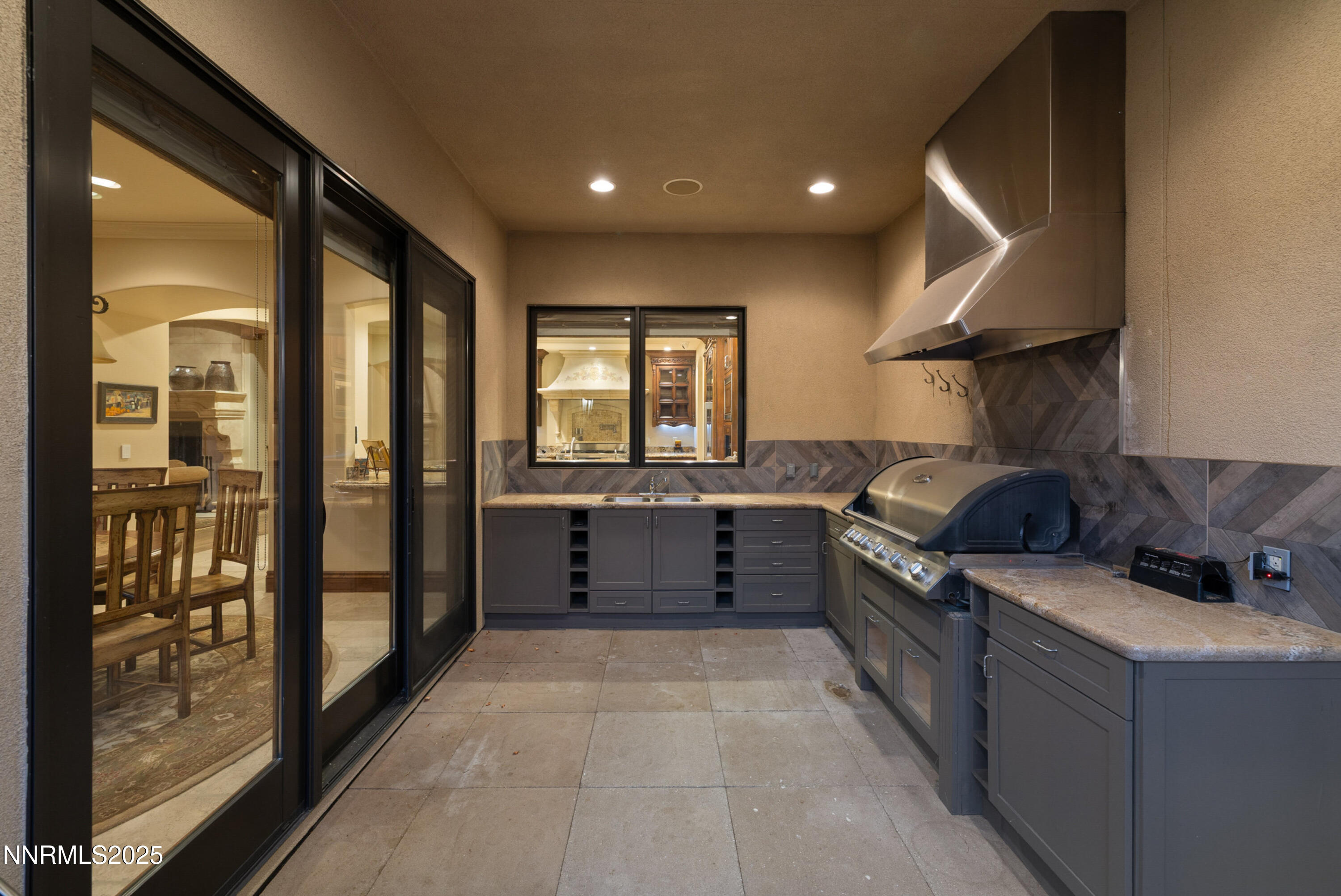 5775 Lausanne Drive Reno, NV 89511 - Photo 52 of 69 a kitchen with granite countertop a refrigerator and wooden cabinets