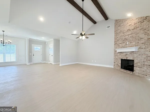 a view of an empty room with a fireplace