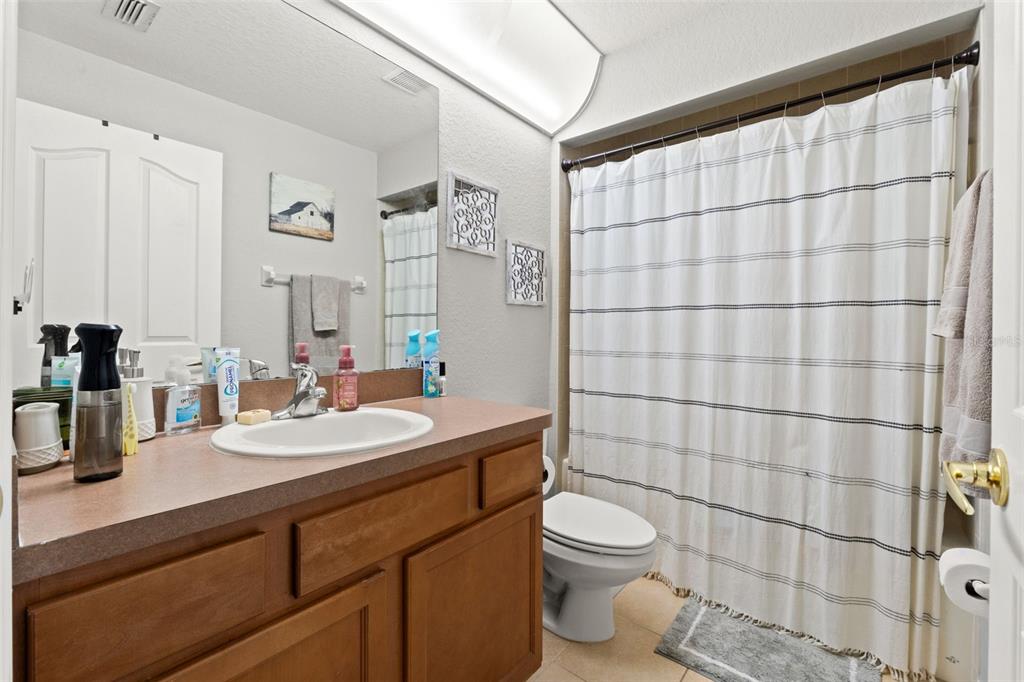 15335 Fleetwood Road Weeki Wachee, FL 34614 - Photo 28 of 40 a bathroom with a double vanity sink toilet and shower