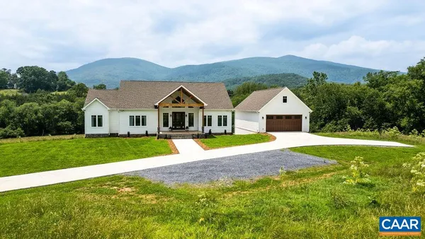 a kitchen with stainless steel appliances granite countertop a kitchen island a stove a table and chairs