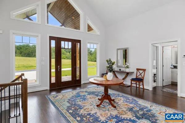 a kitchen with stainless steel appliances granite countertop a sink a stove and a wooden floors