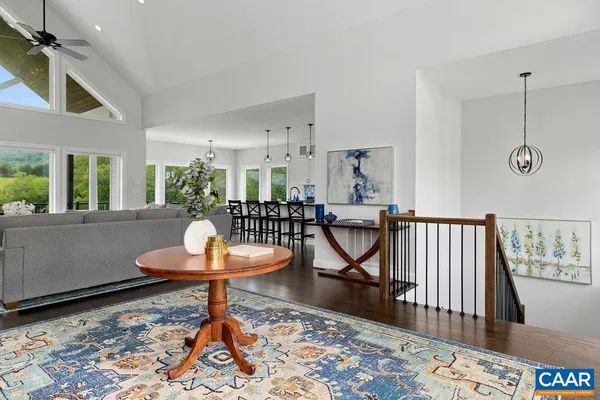 a living room with fireplace furniture and a large window