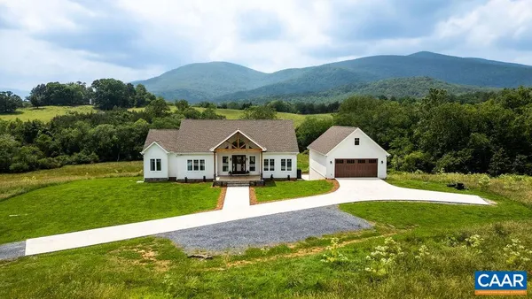 a front view of house with yard and green space