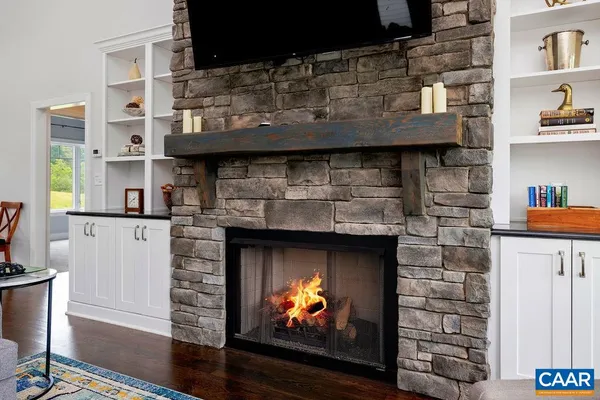 a spacious bedroom with a bed and a flat tv screen