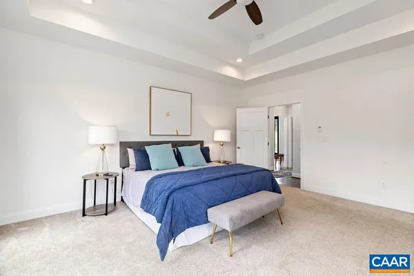 an aerial view of a house with a yard and lake view